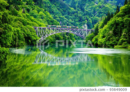 Tadami Line Kiha E120 train crossing the fresh green Daiichi Tadami River Bridge (Mishima Town, Fukushima Prefecture, mid-May) 93649009