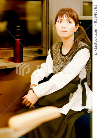 A cute girl on her way home on a local train after work 93649563