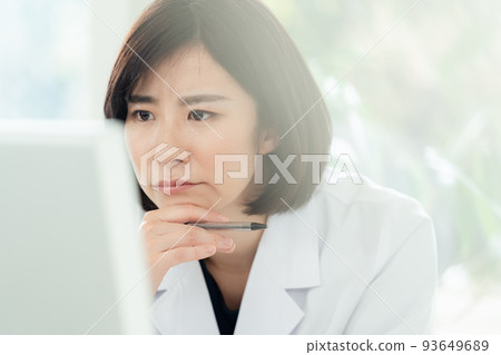 Worried woman in white coat Worried woman in white coat 93649689