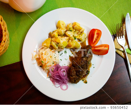 Plate with a meat dish lula-kebab and stewed potatoes. 93650452