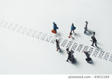 Miniature people walking beside chronology 93652269