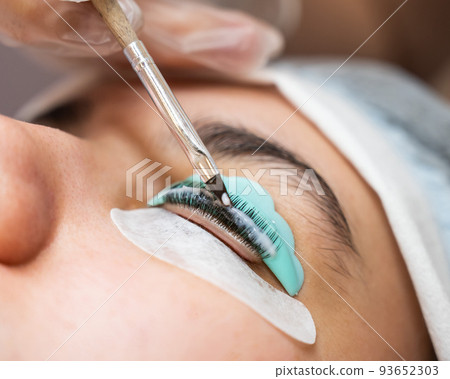 Close-up portrait of a woman on eyelash lamination procedure.  93652303