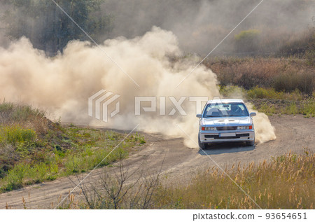 Sports Car on the Turn of the Rally Track and a Lot of Dust 10 93654651