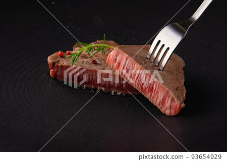 Lifting the beef tenderloin thick cut steak 93654929