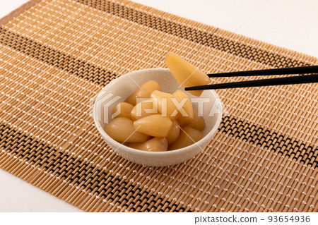 Tamari pickled shallots in a small bowl with chopsticks, home cooking Tamari pickled shallots in a small bowl with chopsticks, home cooking 93654936