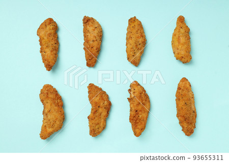 Concept of tasty food with Chicken strips on blue background Concept of tasty food with Chicken strips on blue background 93655311