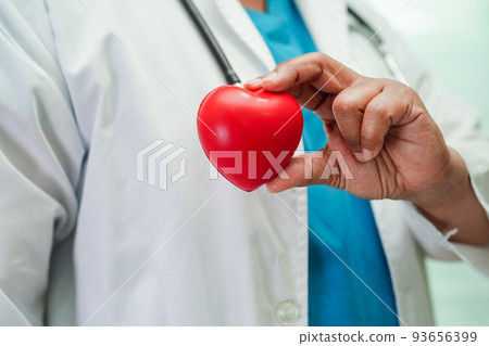 Asian woman doctor holding red heart for health in hospital. 93656399