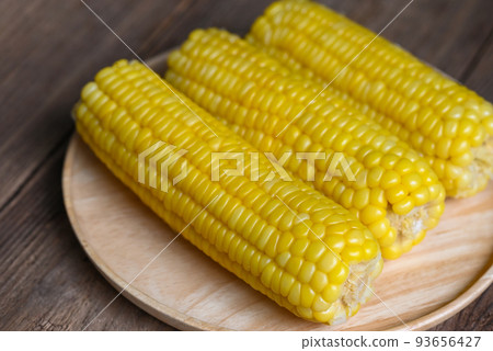 cooked sweet corn on wooden plate background, ripe corn cobs steamed or boiled sweetcorn for food vegan dinner or snack cooked sweet corn on wooden plate background, ripe corn cobs steamed or boiled sweetcorn for food vegan dinner or snack 93656427