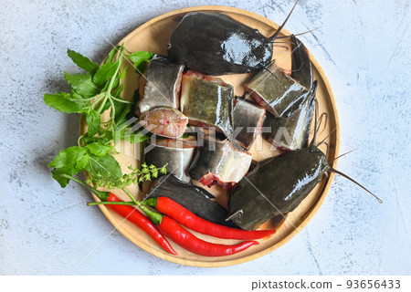 catfish for cooking food, fish chopped with ingredients herb and spices, fresh raw catfish menu freshwater fish, catfish fillet on wooden plate catfish for cooking food, fish chopped with ingredients herb and spices, fresh raw catfish menu freshwater fish, catfish fillet on wooden plate 93656433