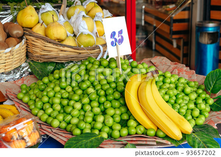 Fruit market counter with assortment of fresh fruits for sale 93657202