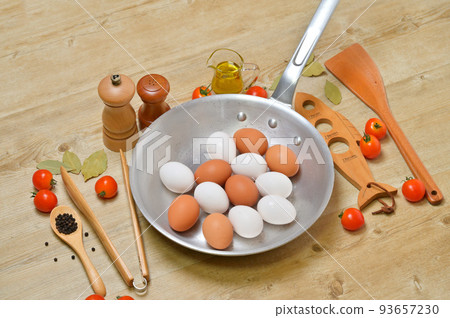 Image of cooking utensils. Aluminum frying pans, utensils, cooking, table. 93657230