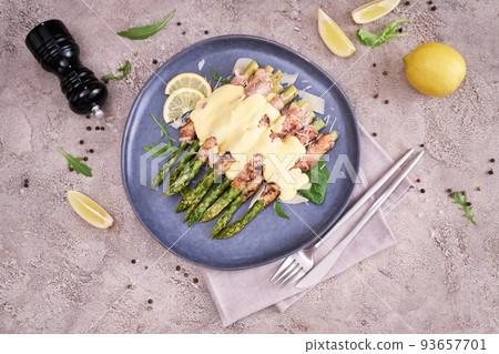 Healthy food - Asparagus wrapped with bacon and spices on a plate 93657701