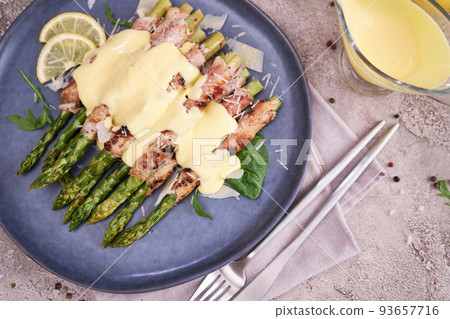 Healthy food - Asparagus wrapped with bacon and spices on a plate Healthy food - Asparagus wrapped with bacon and spices on a plate 93657716