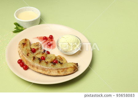 Concept of tasty food with grilled banana on green background 93658083