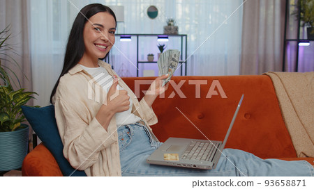 Young woman using credit bank card and laptop, transferring money, purchases online shopping Young woman using credit bank card and laptop, transferring money, purchases online shopping 93658871