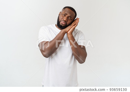 Young african american man with afro hair sleeping tired dreaming and posing with hands together while smiling with closed eyes 93659130