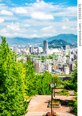 A view of Kamiyacho in the center of the city from near the hill (Ryuo Park) in the western part of Hiroshima City. You can see the golden mountain in the background 93659876