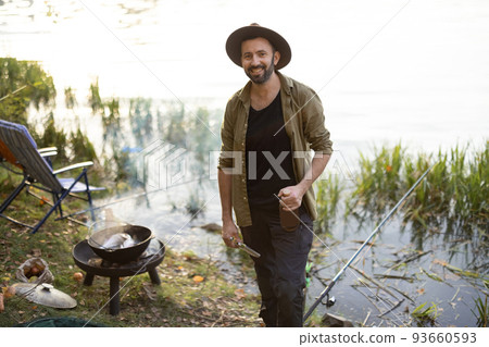 Caucasian man fishing on lake 93660593