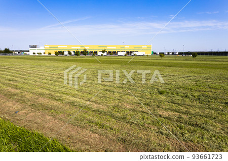 Logistics warehouse center, loading hub, and trucks with cargo trailers standing near the ramps Logistics warehouse center, loading hub, and trucks with cargo trailers standing near the ramps 93661723