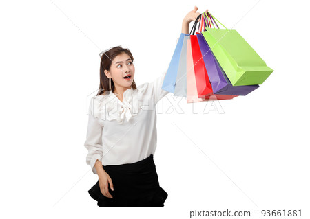 Portrait of an excited beautiful woman holding shopping bags isolated on white background. Portrait of an excited beautiful woman holding shopping bags isolated on white background. 93661881