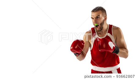 The spirit of victory. Male boxer in red uniform and boxing gloves training isolated on white background. Strength, attack and motion, betting concept. 93662807