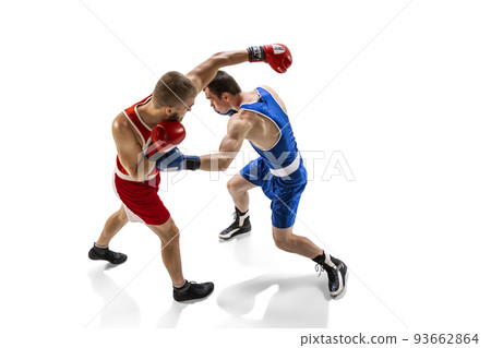 Fight. Professional male boxer in sports uniform and gloves training isolated on white background. Concept of sport, competition, training, energy 93662864