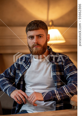 Portrait handsome bearded man wearing plaid shirt at modern cafe. Portrait handsome bearded man wearing plaid shirt at modern cafe. 93662866