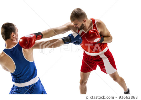 Dynamic portrait of two professional boxer in sports uniform boxing isolated on white background. Concept of sport, competition, training, energy Dynamic portrait of two professional boxer in sports uniform boxing isolated on white background. Concept of sport, competition, training, energy 93662868