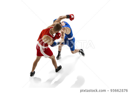 Young men, professional boxers in sports uniform boxing isolated on white studio background. Concept of sport, competition, training, energy Young men, professional boxers in sports uniform boxing isolated on white studio background. Concept of sport, competition, training, energy 93662876