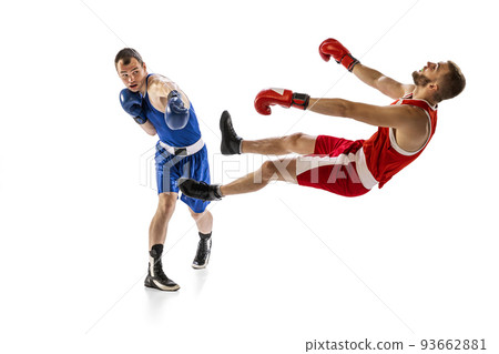 Knockout punch. Two male professional boxers boxing isolated on white studio background. Concept of sport, competition, training, energy Knockout punch. Two male professional boxers boxing isolated on white studio background. Concept of sport, competition, training, energy 93662881