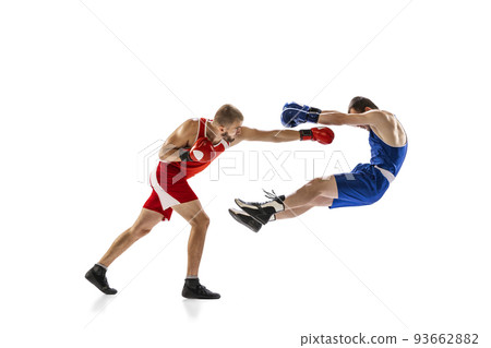 Knockout punch. Two male professional boxers boxing isolated on white studio background. Concept of sport, competition, training, energy Knockout punch. Two male professional boxers boxing isolated on white studio background. Concept of sport, competition, training, energy 93662882