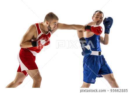 Dynamic portrait of two professional boxer in sports uniform boxing isolated on white background. Concept of sport, competition, training, energy Dynamic portrait of two professional boxer in sports uniform boxing isolated on white background. Concept of sport, competition, training, energy 93662885