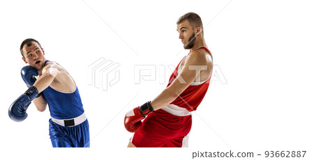 Sportive men, two professional boxer in sports uniform practicing punch isolated on white background. Concept of sport, competition, training, energy 93662887