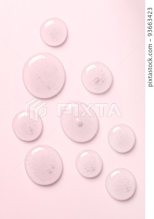 Pink drops of gel closeup. Cosmetic product for moisturizing the skin of the face or body. 93663423