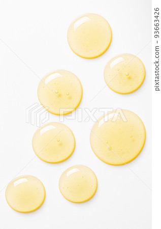 Yellow drops of gel close up. Cosmetic product for moisturizing the skin of the face or body. 93663426