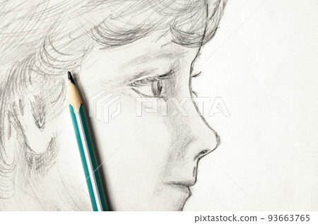 A child's face drawn in pencil. Sketch on paper. The concept of learning to draw 93663765