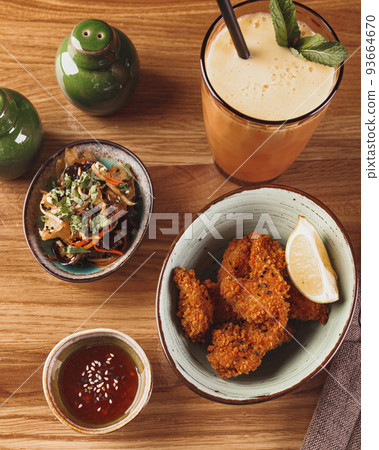 Chicken Karaage with salad, sauce and milkshake on wooden table Chicken Karaage with salad, sauce and milkshake on wooden table 93664670