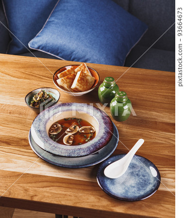 Asian style soup with mushrooms, miso soup in bowl on wooden table Asian style soup with mushrooms, miso soup in bowl on wooden table 93664673