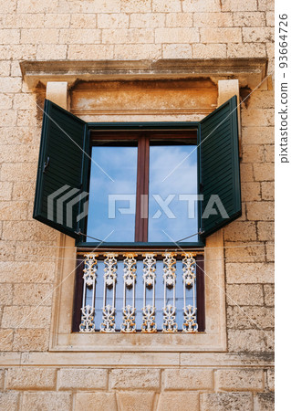 Window in an old historic building. Retro architecture. Summer in Croatia. Dubrovnik Window in an old historic building. Retro architecture. Summer in Croatia. Dubrovnik 93664726