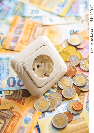 Electric socket and euro money. Concept of increasing electricity prices. Electric socket and euro money. Concept of increasing electricity prices. 93665534