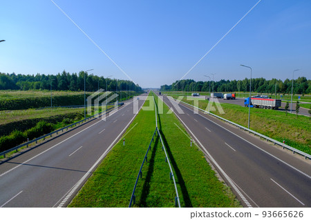 Expressway in several lanes S2 in Poland and a stop with several trucks. Summer August. 93665626