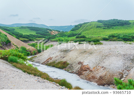 warm hydrogen sulfide stream among the banks of volcanic ash and tephra in the caldera of Golovnin volcano, Kunashir island 93665710