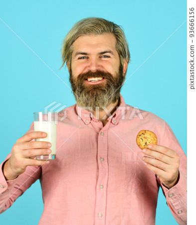 Leave it for Santa. Breakfast or lunch. Milk and sweet cookies. Happy hipster eat cookie dessert. Delicious treats. Homemade is best. Recipe for baking cookies. Bearded man drink milk with cookies 93666156
