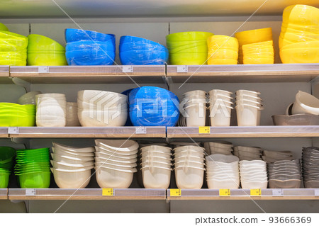 Shelves in the store with plastic storage bowls. Inexpensive alternative to subjects made from natural materials. Set of plastic baskets and boxes in shop. Shelves in the store with plastic storage bowls. Inexpensive alternative to subjects made from natural materials. Set of plastic baskets and boxes in shop. 93666369
