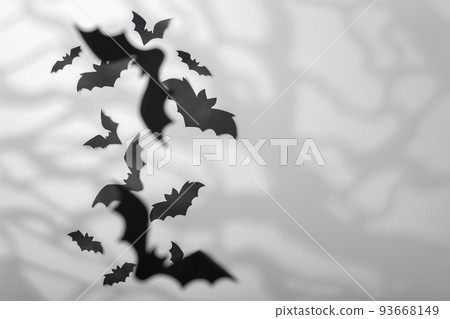 Halloween decoration concept - black paper bats and scary trees shadows background Halloween decoration concept - black paper bats and scary trees shadows background 93668149