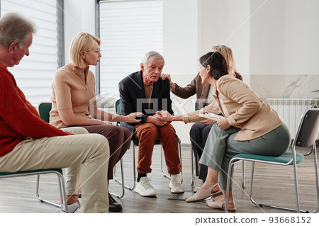 People talking to depressed man People talking to depressed man 93668152