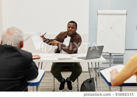 Man teaching people at training 93668335