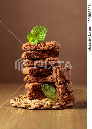 Brownie with mint on a wooden table. Brownie with mint on a wooden table. 93668738