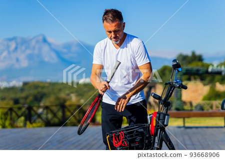 old-aged man good loking outdoors with eco scooter enjoying vacation old-aged man good loking outdoors with eco scooter enjoying vacation 93668906