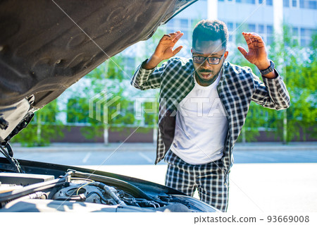 latin hispanic stressed man having trouble with his broken car outdoors latin hispanic stressed man having trouble with his broken car outdoors 93669008